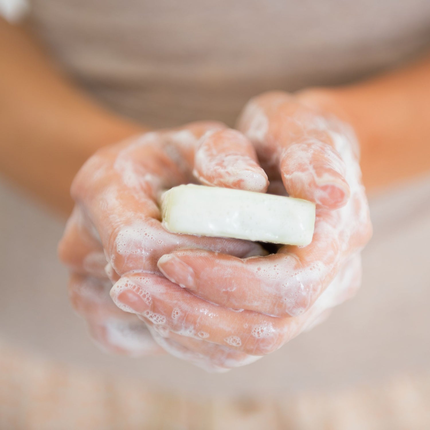 a woman washing her hands with salt soap