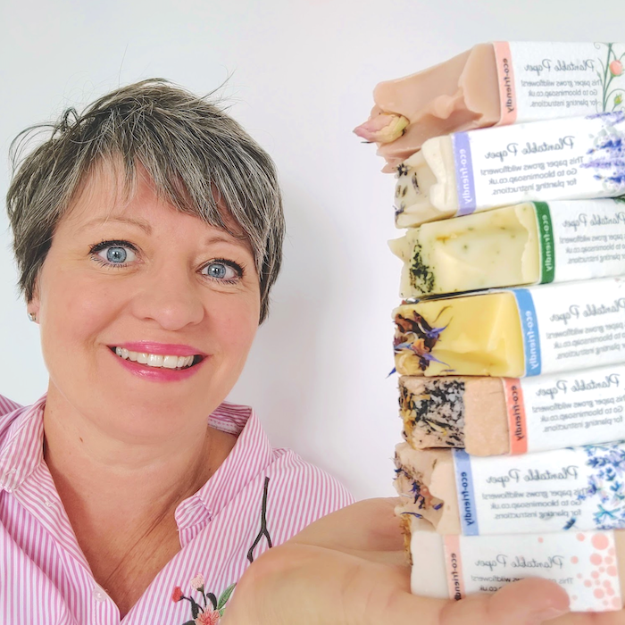 A woman holding a stack of natural soap bars