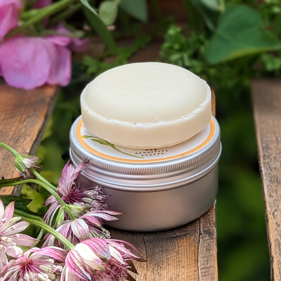 Delicate Flower solid shampoo bar on an aluminium tin