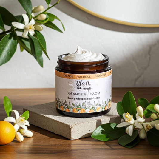Orange Blossom body butter on a stone with orasnge blossom