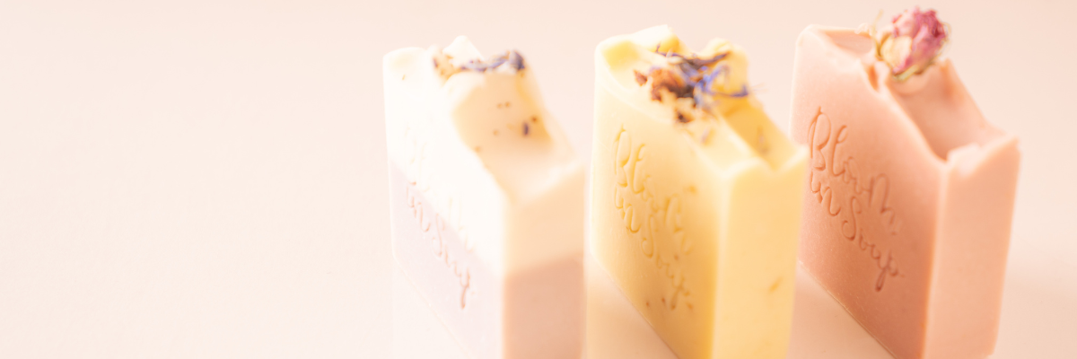 three natural soap bars in pink yellow and lavender