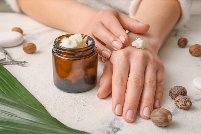 a woman applying whipped shea butter body butter
