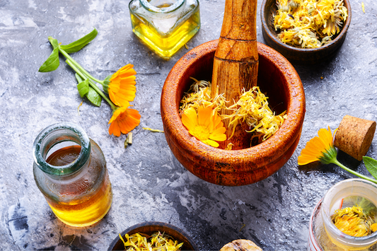 a bowl of calendula petals and flowers for use in natural skincare