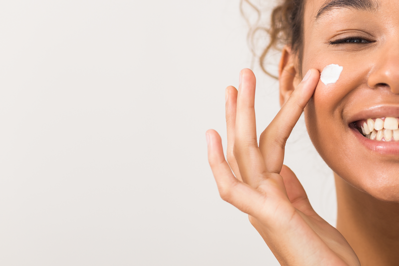 woman applying skin cream
