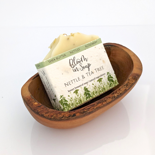 natural soap bar in an olive wood soap dish