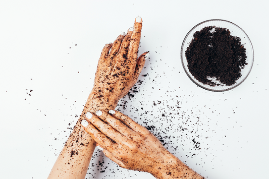 woman exfoliating her skin with coffee