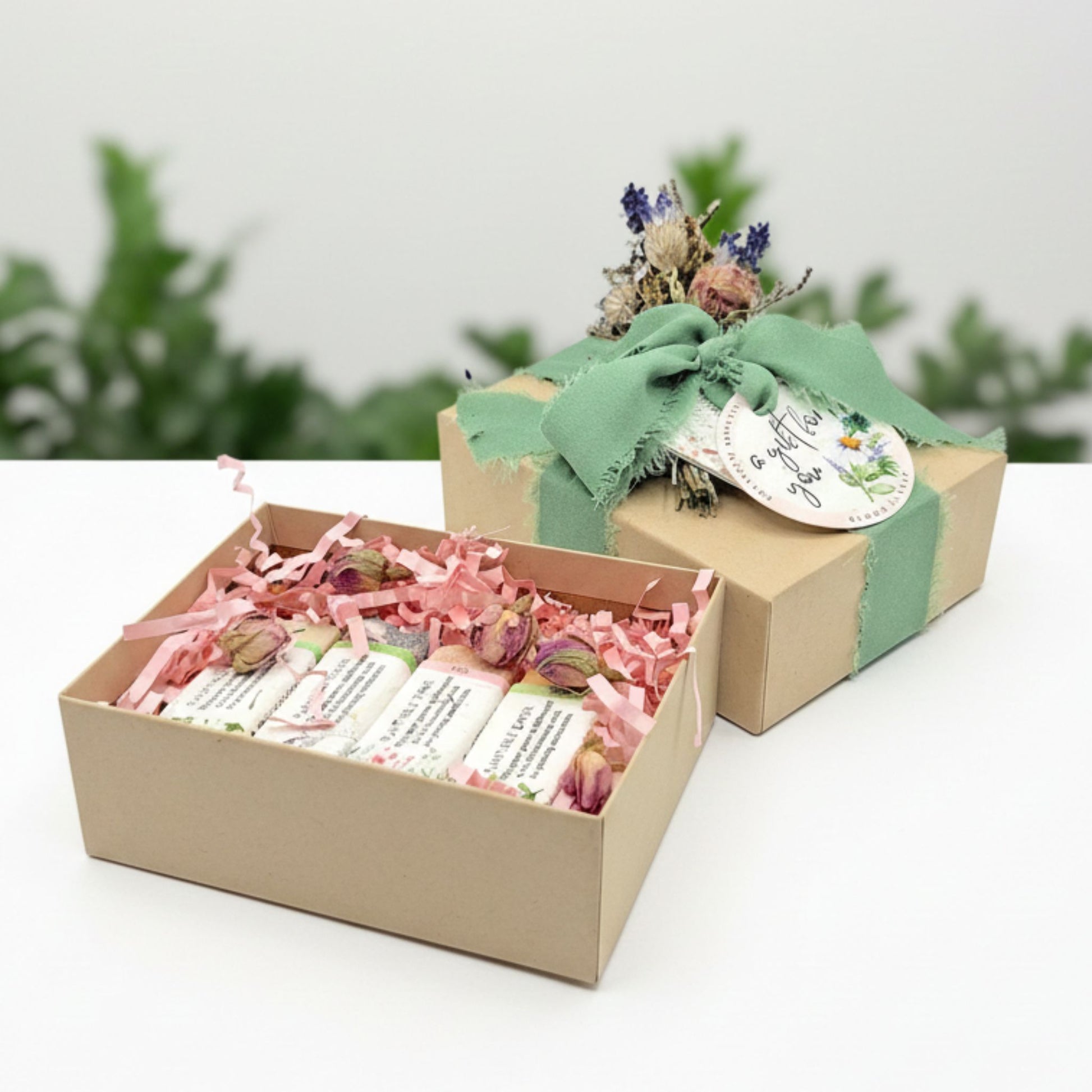 Gift box with soaps inside and a green ribbon