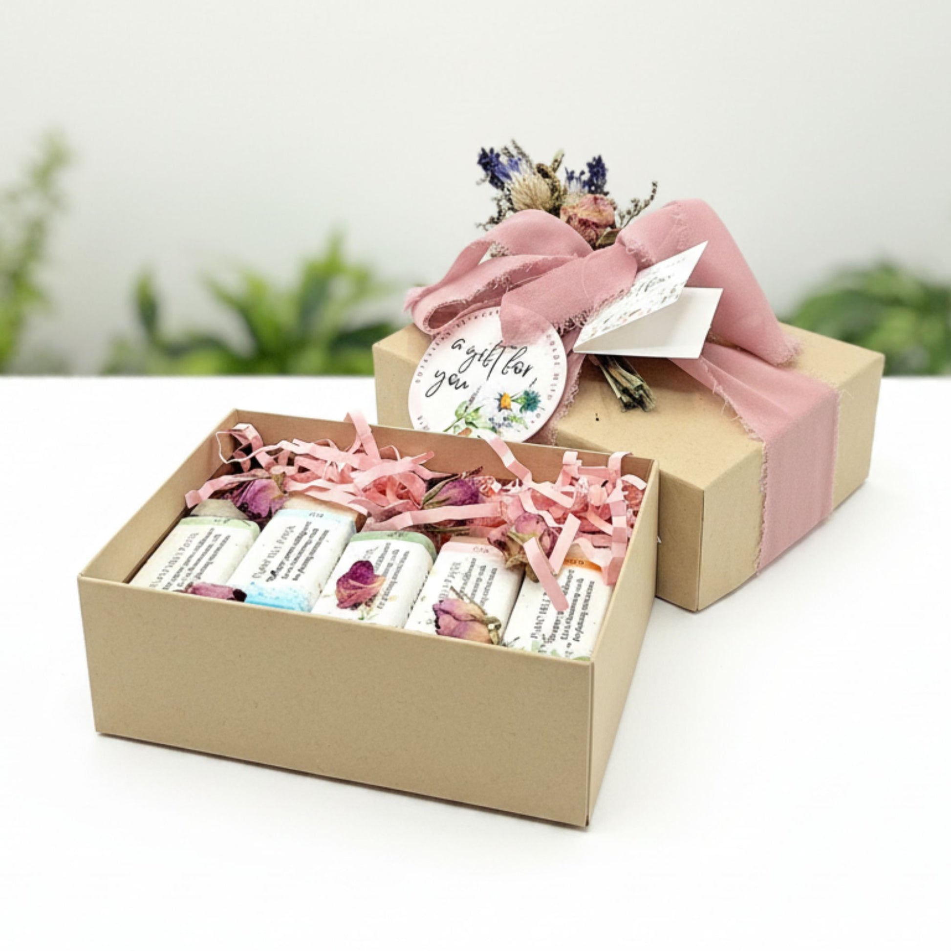 Gift box with five soaps inside and decorated with pink ribbon