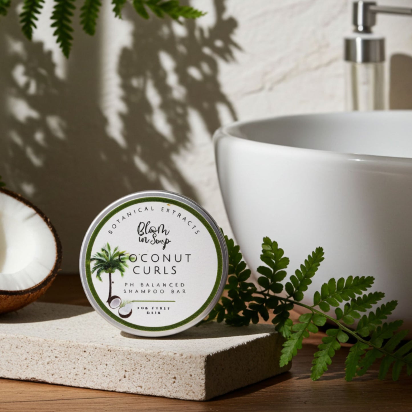 Coconut Curls shampoo bar on a bathroom counter with a sink and coconut in the background