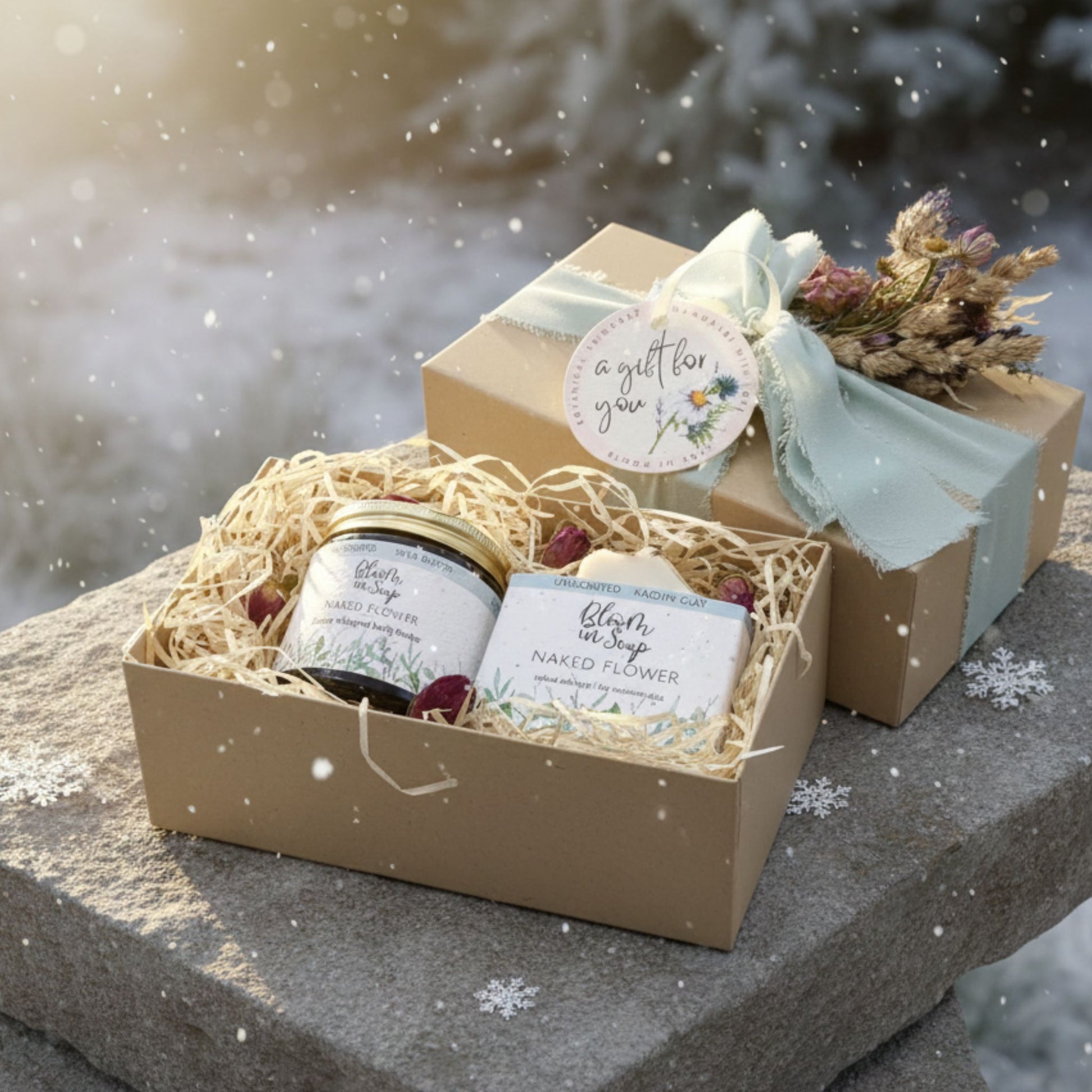 Gift set with a jar, soap, and decorative elements on a stone surface with a snowy background.