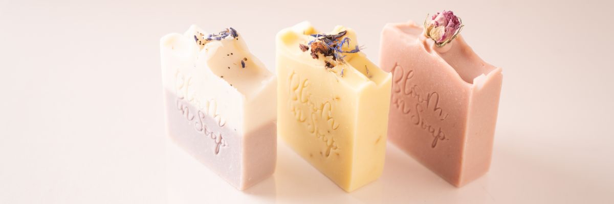 Three rectangular soap bars with decorative elements on a light background