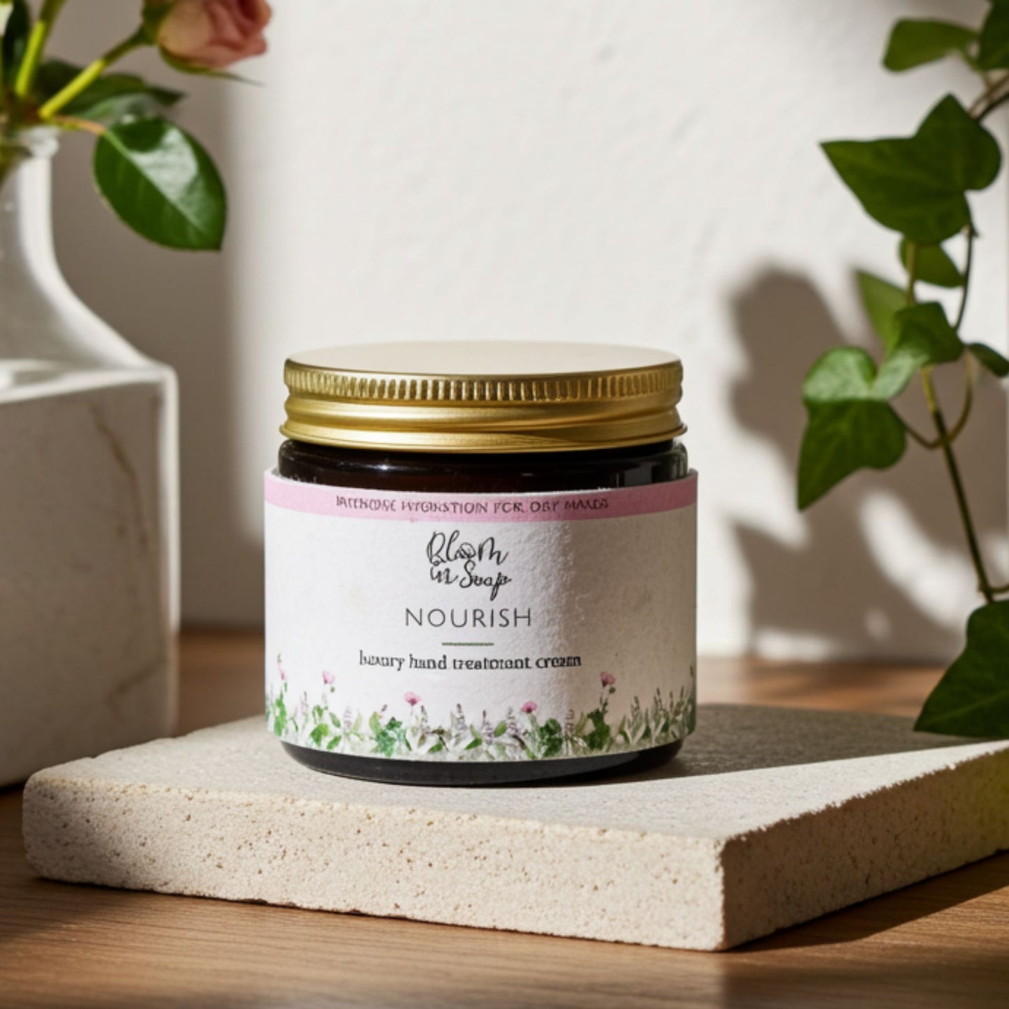 Jar of hand treatment cream with floral design on a wooden surface