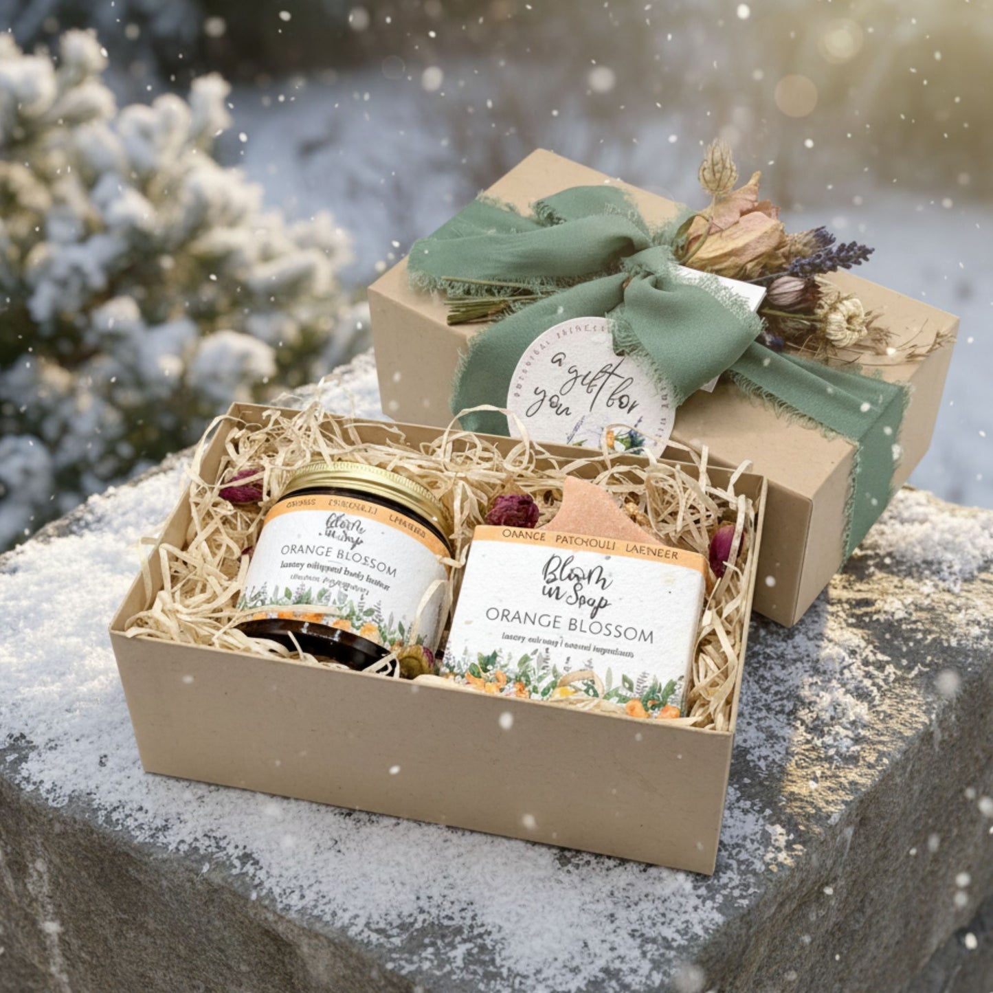 Gift box with soap and body butter set on a snowy surface