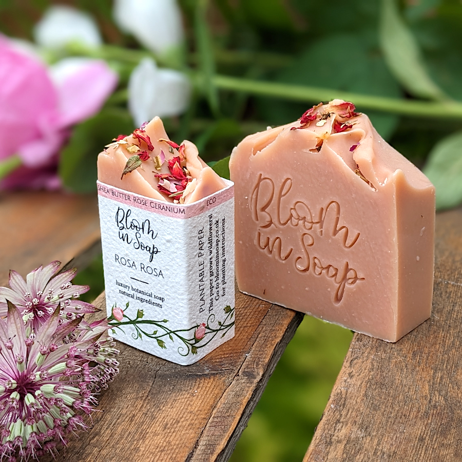 Rose handmade soap on a wooden tray with plants