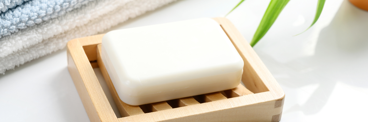 a bamboo soap dish with a natural soap bar