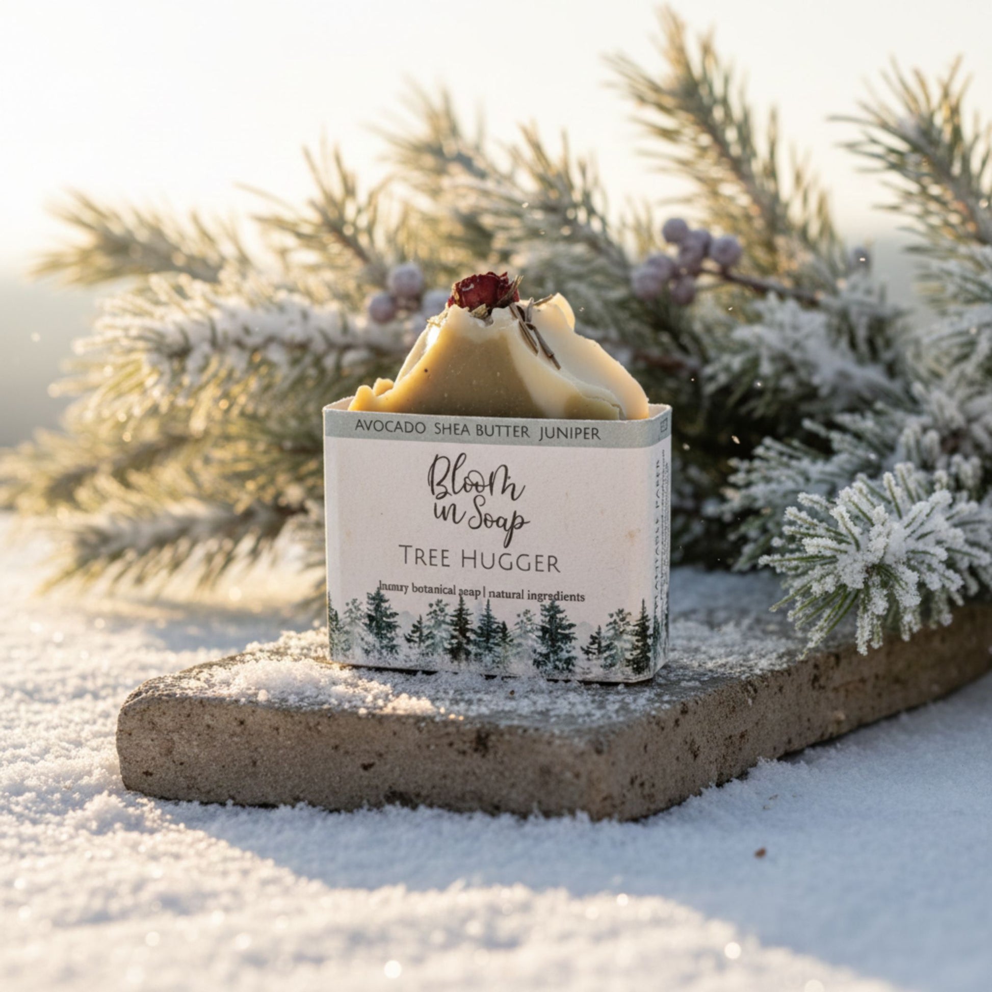 Bar of soap with a 'Tree Hugger' label in front of snow-covered branches