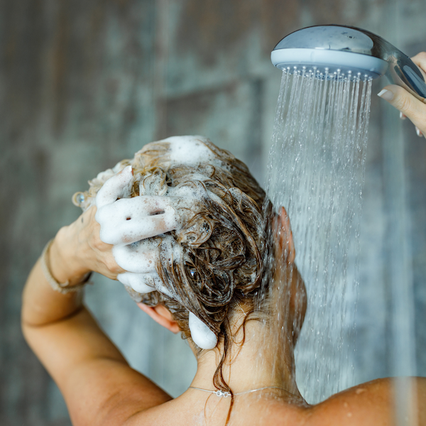 A woman washing her hair with a shampoo bar